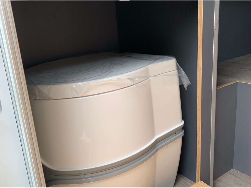 Cupboard with camping toilet inside