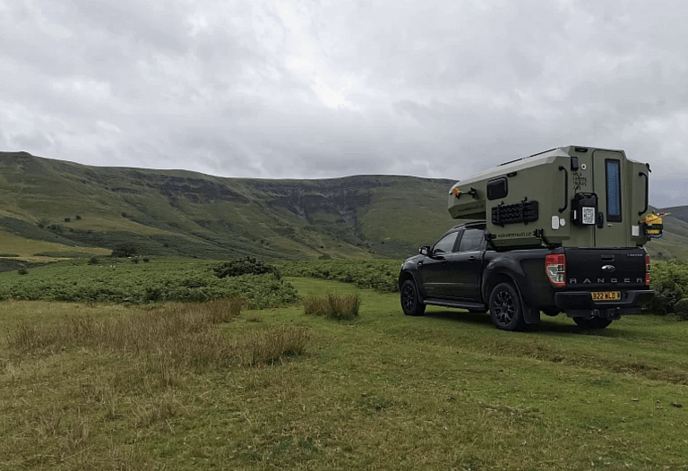 Wild Camper Truck in the wilderness looking out at the mountains